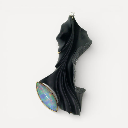 A black chalcedony carving by Steve Walters in an 18kt brooch and pendant with a diamond and Australian opal, made by ART Guyon for Cynthia Scott Jewelry.