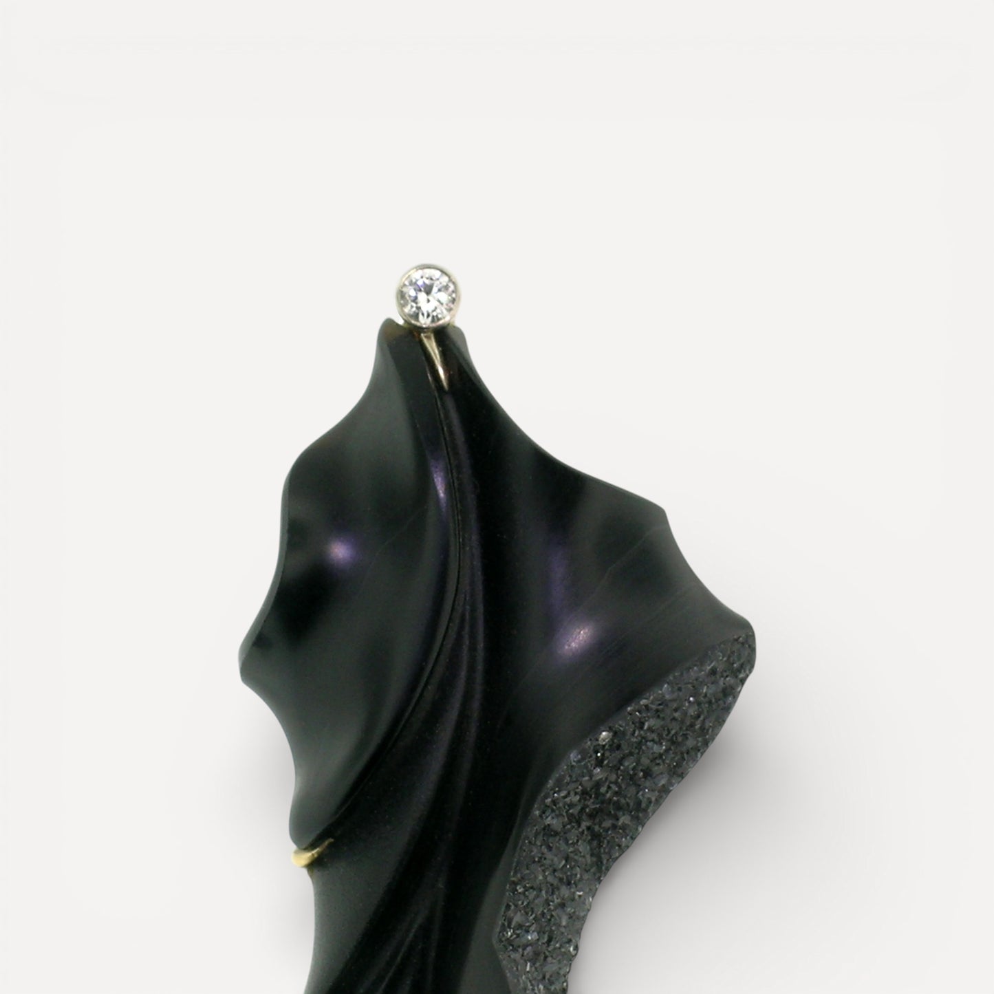 A black chalcedony carving by Steve Walters in an 18kt brooch and pendant with a diamond and Australian opal, made by ART Guyon for Cynthia Scott Jewelry.