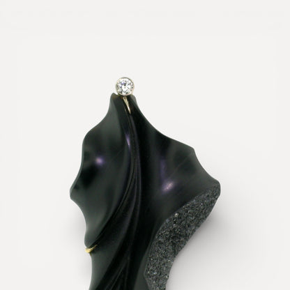 A black chalcedony carving by Steve Walters in an 18kt brooch and pendant with a diamond and Australian opal, made by ART Guyon for Cynthia Scott Jewelry.