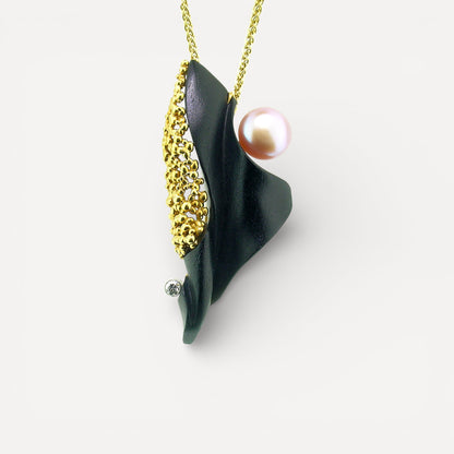 A black chalcedony carving by Steve Walters in an 18kt pendant and brooch with granulation, a diamond, and a pearl by ART Guyon for Cynthia Scott Jewelry.