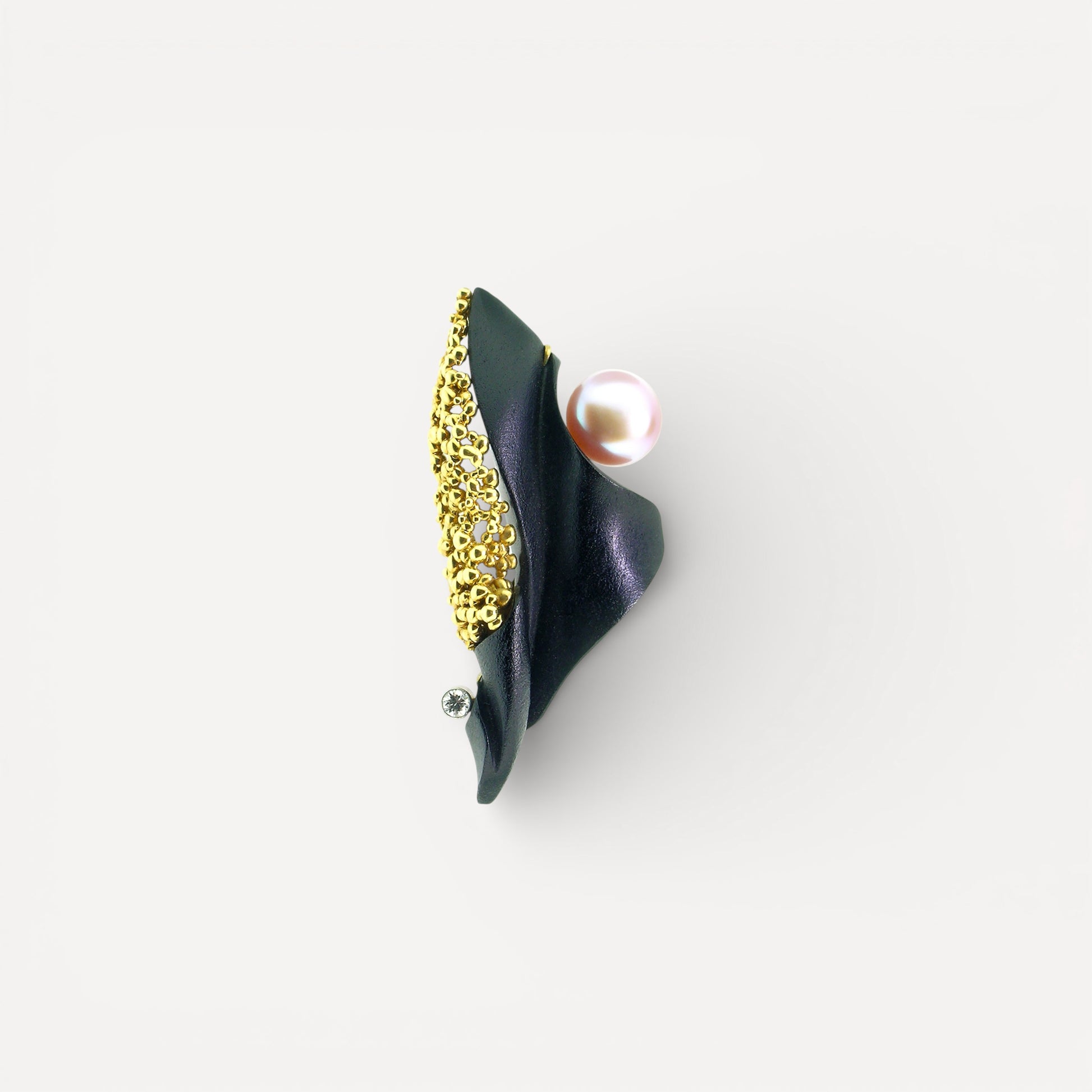 A black chalcedony carving by Steve Walters in an 18kt pendant and brooch with granulation, a diamond, and a pearl by ART Guyon for Cynthia Scott Jewelry.