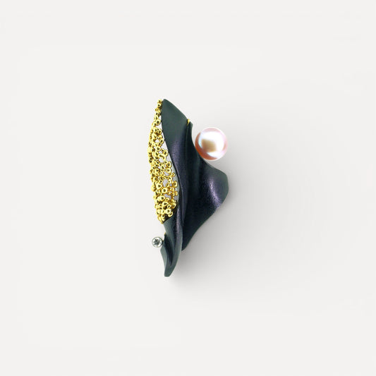 A black chalcedony carving by Steve Walters in an 18kt pendant and brooch with granulation, a diamond, and a pearl by ART Guyon for Cynthia Scott Jewelry.