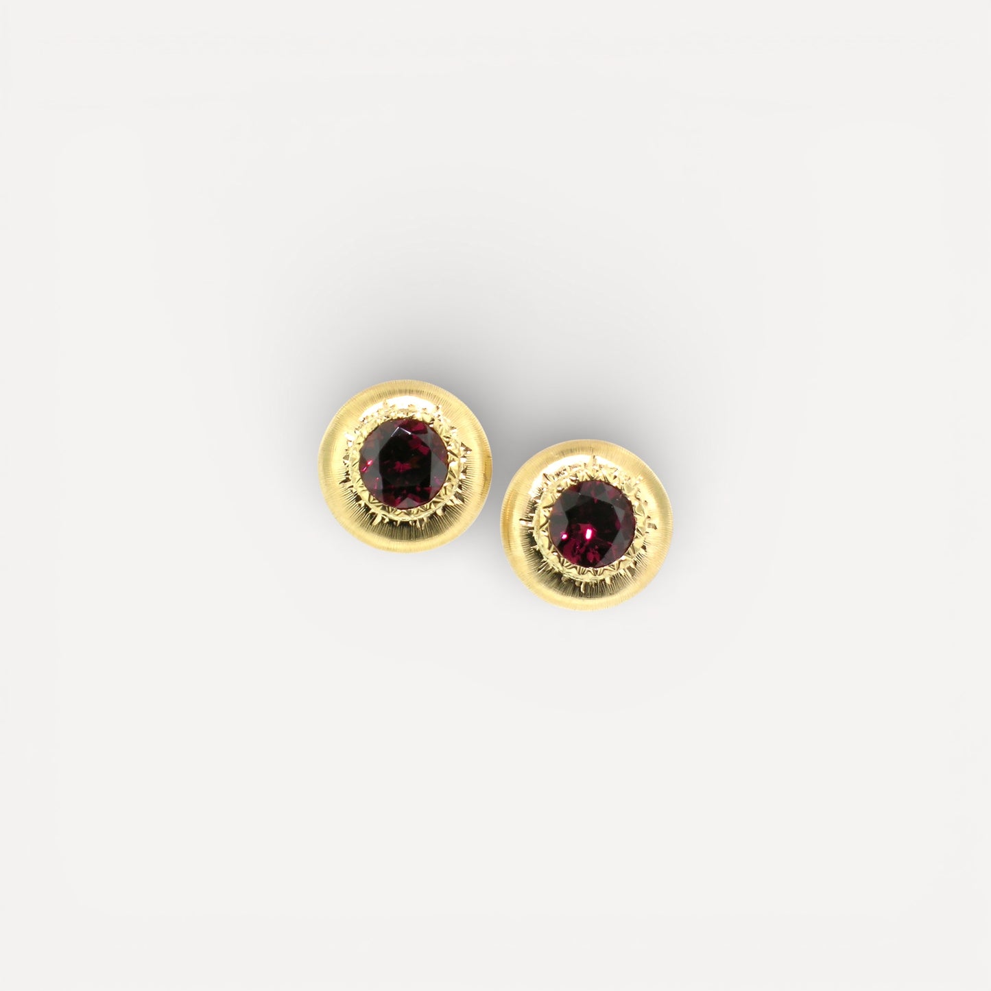 A pair of 18kt yellow gold earrings, Florentine engraved, featuring a pair of Rhodolite Garnets. Made in Florence, Italy for Cynthia Scott Jewelry.