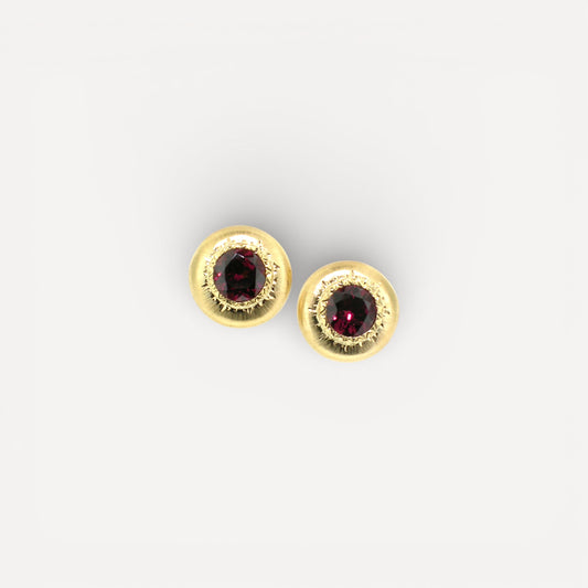 A pair of 18kt yellow gold earrings, Florentine engraved, featuring a pair of Rhodolite Garnets. Made in Florence, Italy for Cynthia Scott Jewelry.