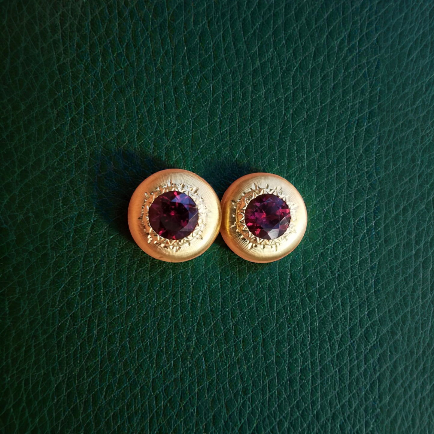 A pair of 18kt yellow gold earrings, Florentine engraved, featuring a pair of Rhodolite Garnets. Made in Florence, Italy for Cynthia Scott Jewelry.