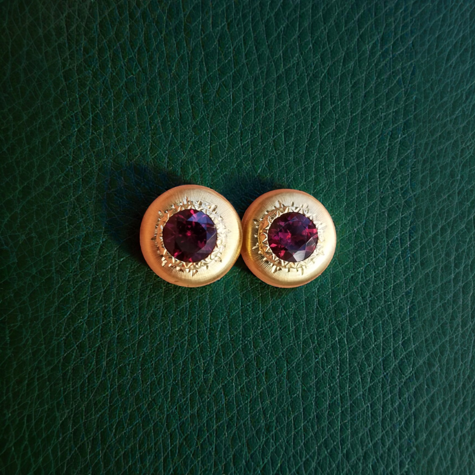 A pair of 18kt yellow gold earrings, Florentine engraved, featuring a pair of Rhodolite Garnets. Made in Florence, Italy for Cynthia Scott Jewelry.