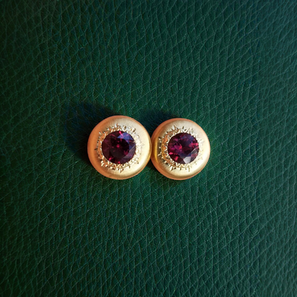 A pair of 18kt yellow gold earrings, Florentine engraved, featuring a pair of Rhodolite Garnets. Made in Florence, Italy for Cynthia Scott Jewelry.