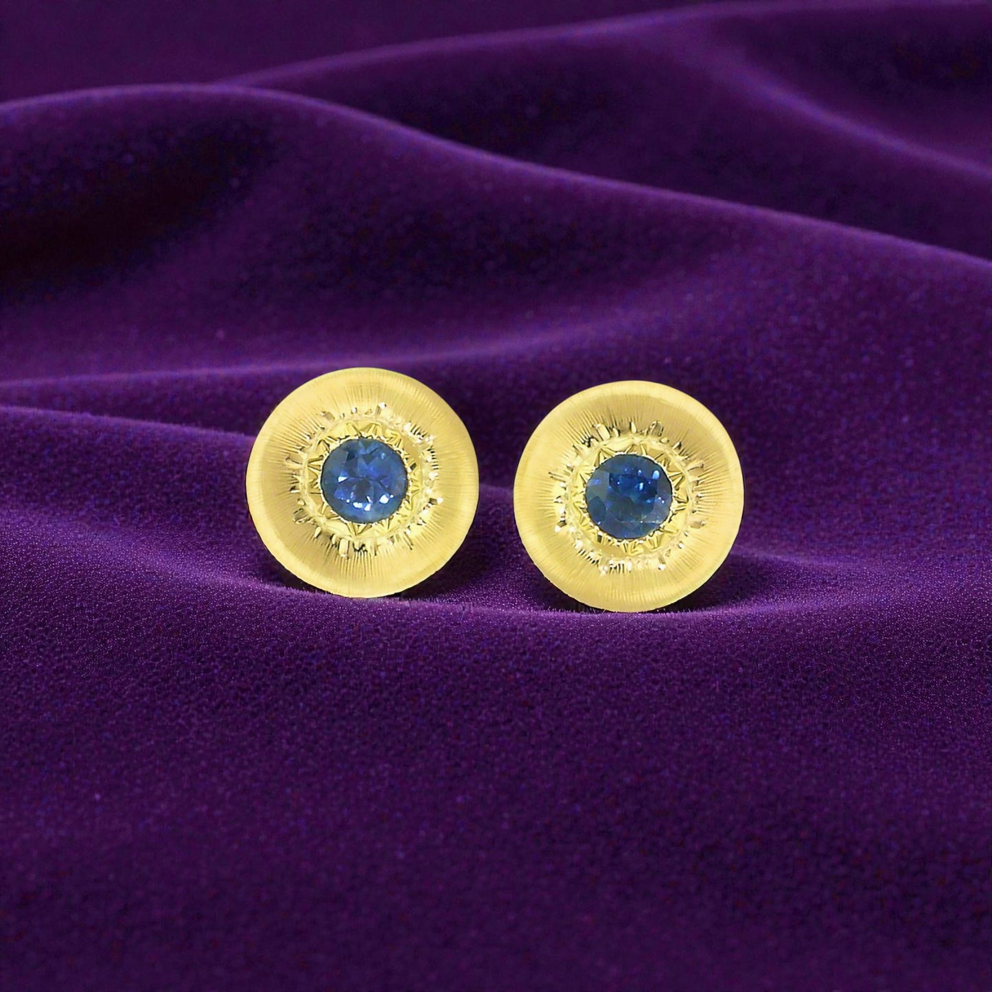 A Florentine engraved pair of 18kt gold earrings with a blue Montana sapphire center. Made in Florence, Italy by Cynthia Scott Jewelry.