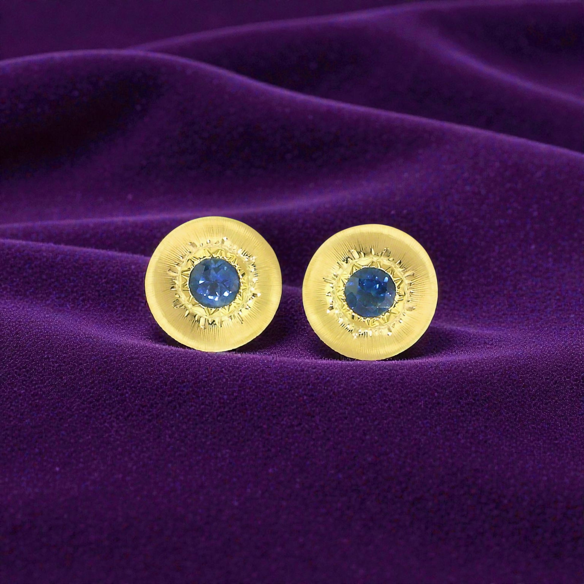 A Florentine engraved pair of 18kt gold earrings with a blue Montana sapphire center. Made in Florence, Italy by Cynthia Scott Jewelry.