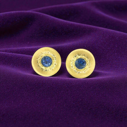 A Florentine engraved pair of 18kt gold earrings with a blue Montana sapphire center. Made in Florence, Italy by Cynthia Scott Jewelry.