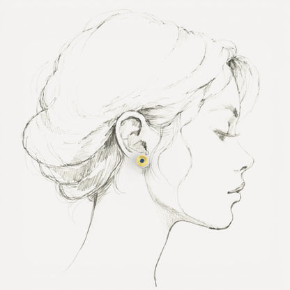 A Florentine engraved pair of 18kt gold earrings with a blue Montana sapphire center. Made in Florence, Italy by Cynthia Scott Jewelry.