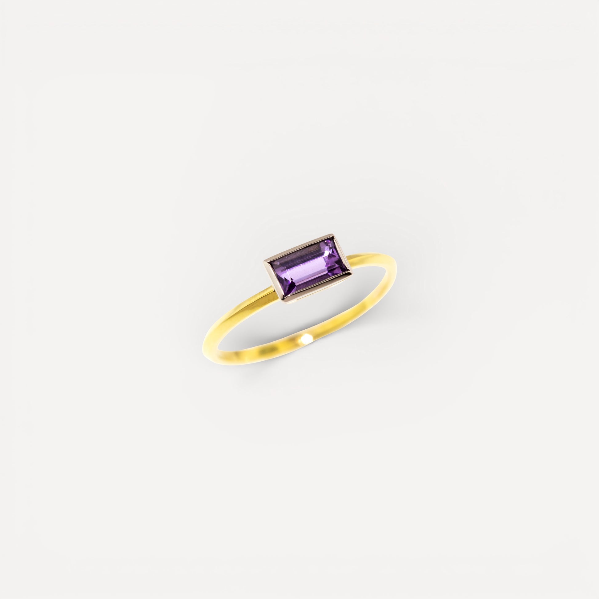 An unheated fancy tanzanite in an 18kt and platinum Paloma ring made in the USA by Cynthia Scott Jewelry